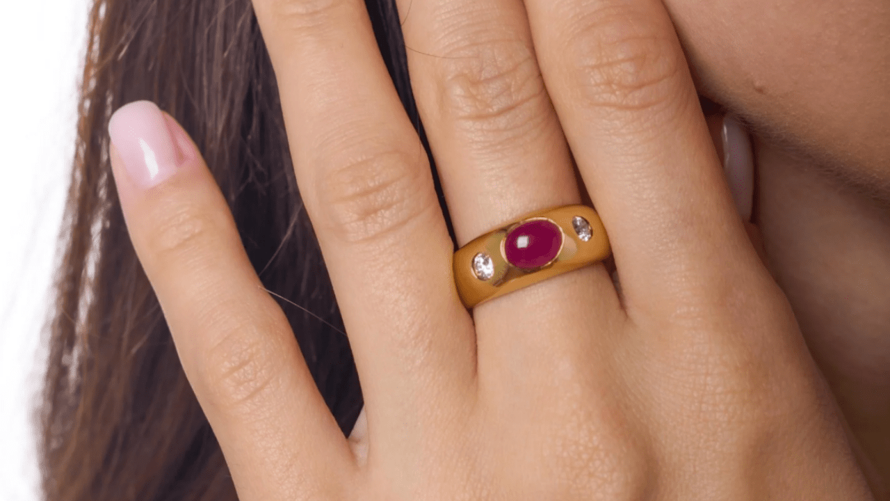 Vintage cabochon cut ruby engagement ring in 18k yellow gold bezel setting with diamond accents, bold vintage ring design