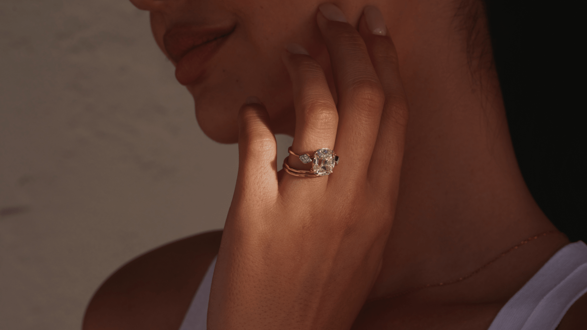 Woman wearing collet style old mine cut diamond engagement ring.