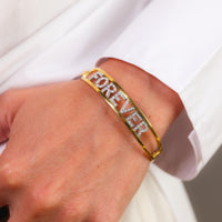 Contemporary diamond 18k yellow and white gold 'forever' bangle