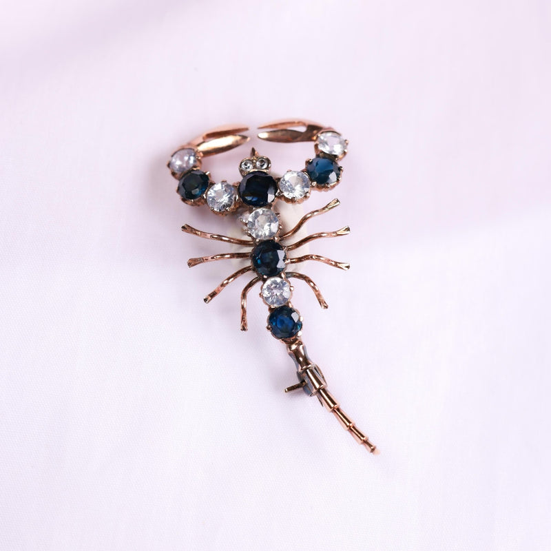 Victorian 4 carat blue and white sapphire 10k rose gold scorpion brooch