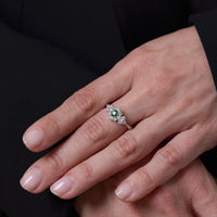 Modern emerald diamond platinum ring