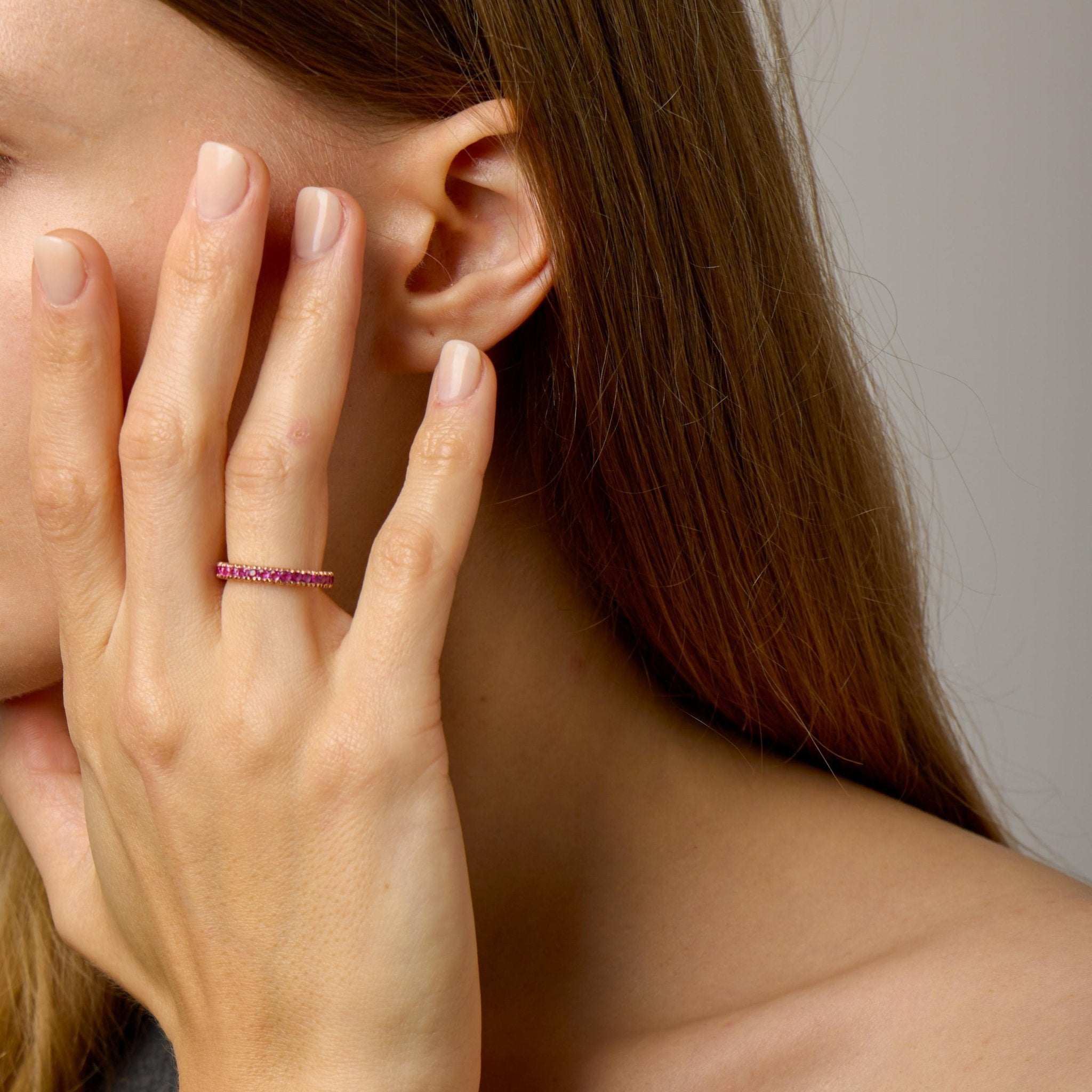 Contemporary pink sapphire 14k rose gold eternity band
