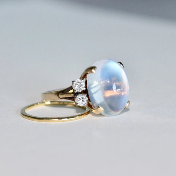 Stillson is a dream retro era and diamond ring set in 14k yellow gold featuring a cabochon moonstone.