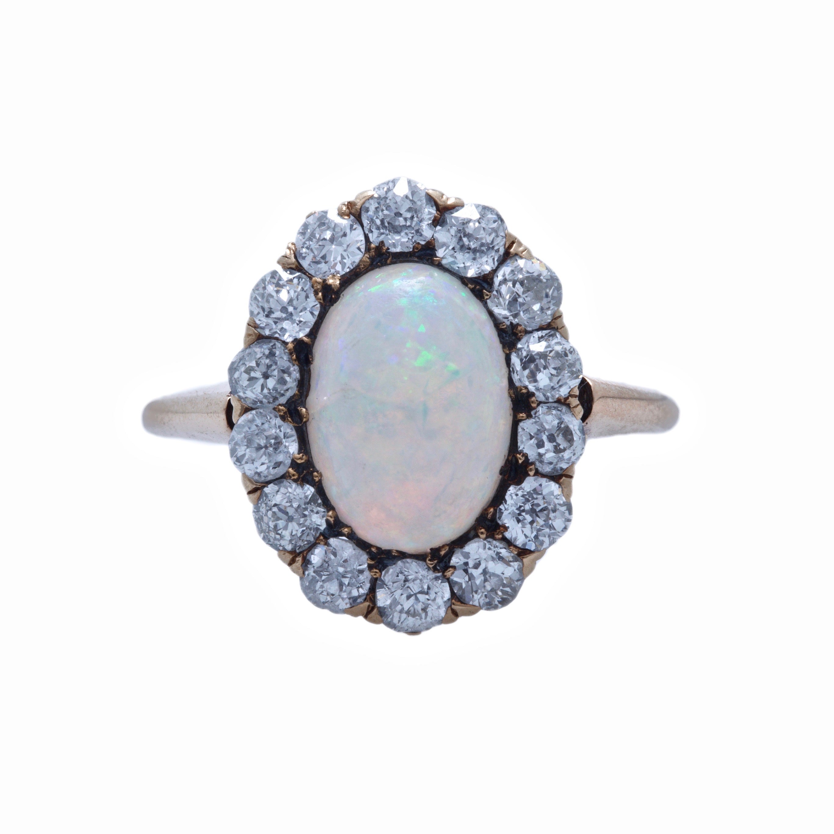 Seagrove | A beautiful and authentic Victorian era oval opal and diamond halo ring in 14k rose gold