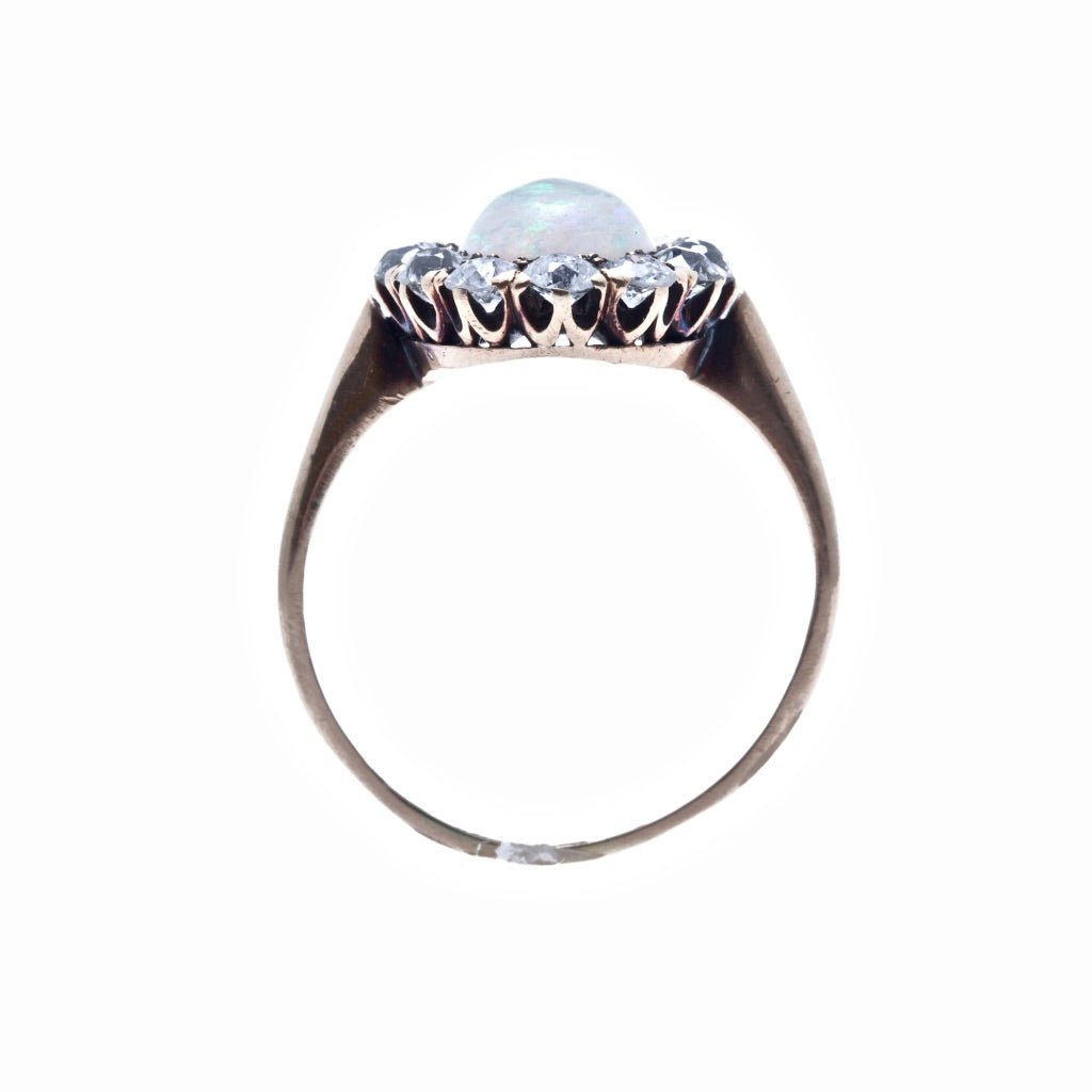 Seagrove | A beautiful and authentic Victorian era oval opal and diamond halo ring in 14k rose gold