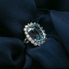 Cape Cod Bay is a stunning 1960s 14k white gold cocktail ring featuring a 15ct aquamarine gemstone surround by a halo of 1.80cts of accent diamonds