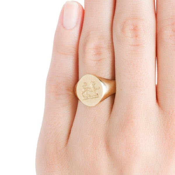 yellow gold crest lion ring on hand