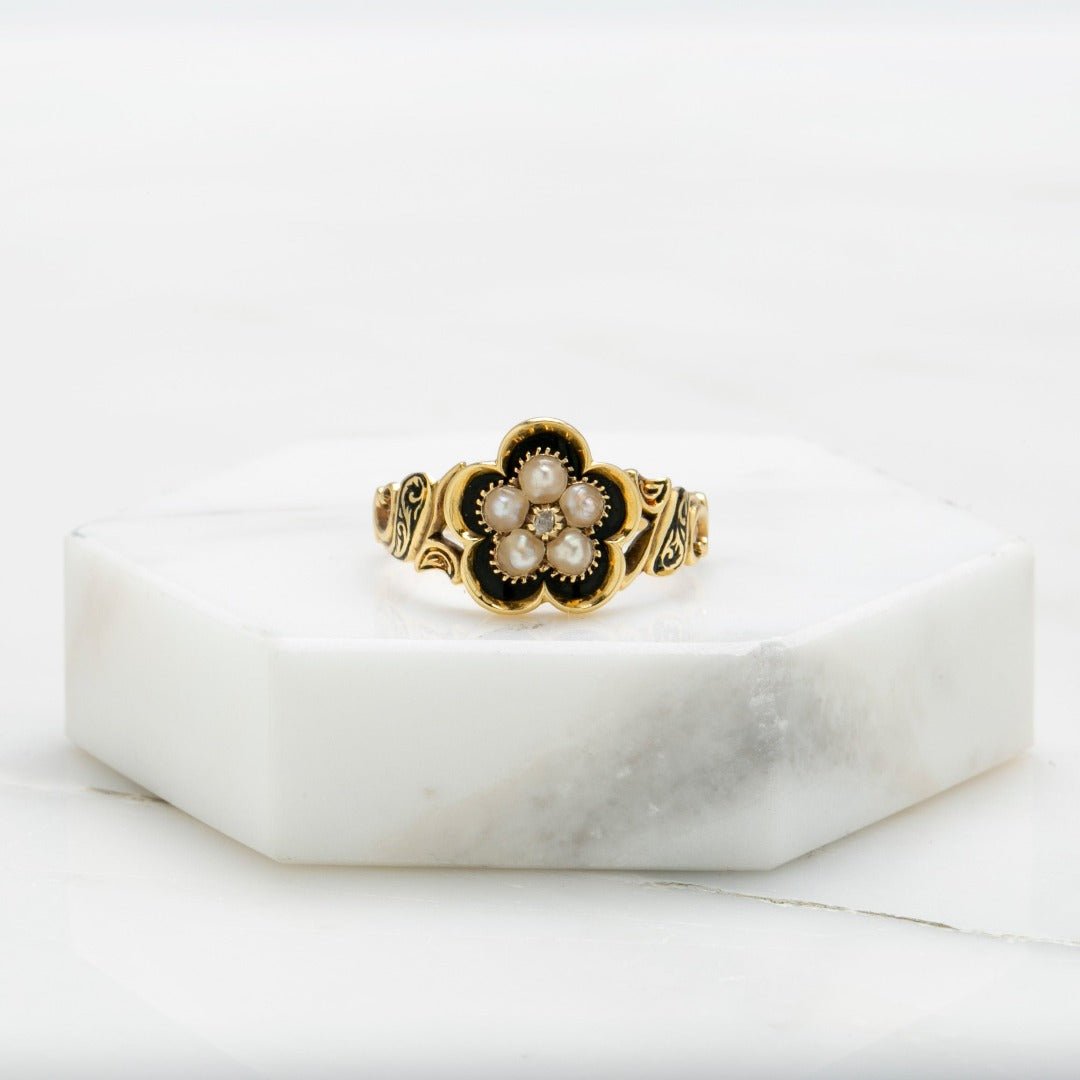 Victorian era mourning ring with seed pearls and blank onyx. English Hallmarks grace the band along with a secret message reading "in memory of"