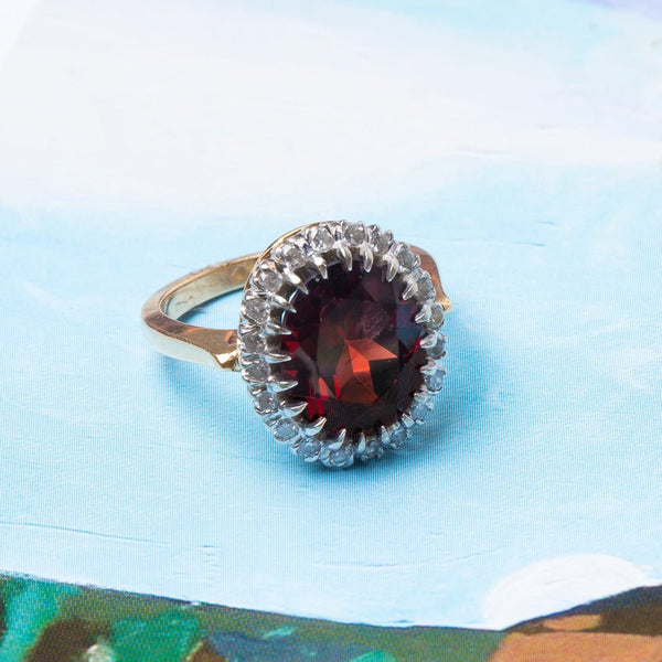 Retro Era Cocktail Ring with Oval Garnet and Diamond Halo | Peppertree Lane from Trumpet & Horn